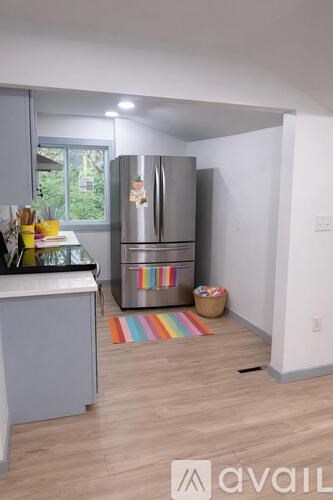 A kitchen with a refrigerator and a counter.