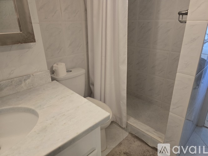 A white toilet sits next to a sink in a bathroom.
