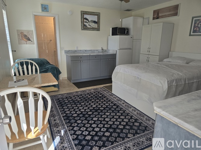 A room with a bed, a chair, and a cabinet.
