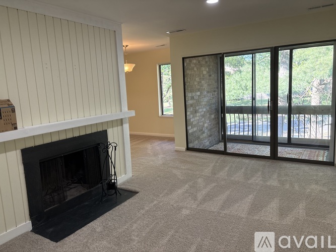 A living room with a fireplace and sliding glass doors.