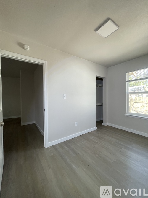 A room with a window and a door.