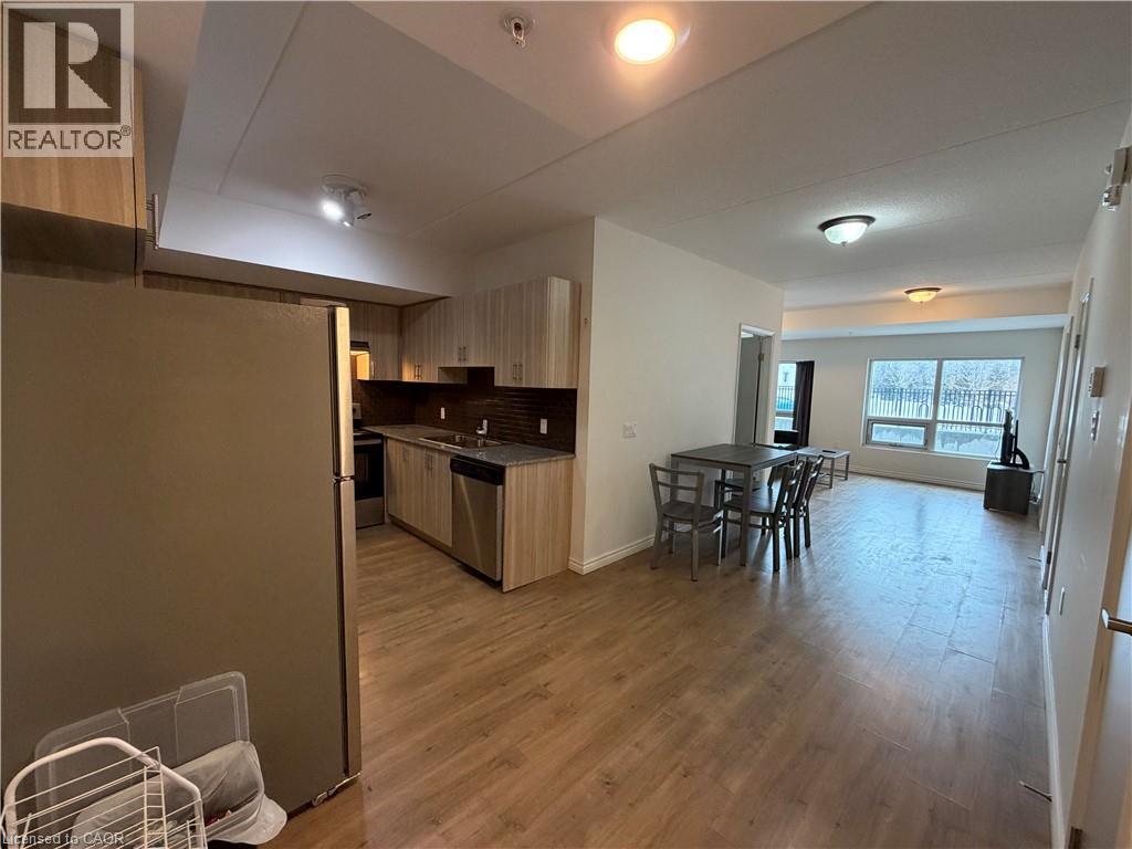 A spacious living area with a dining table and chairs.