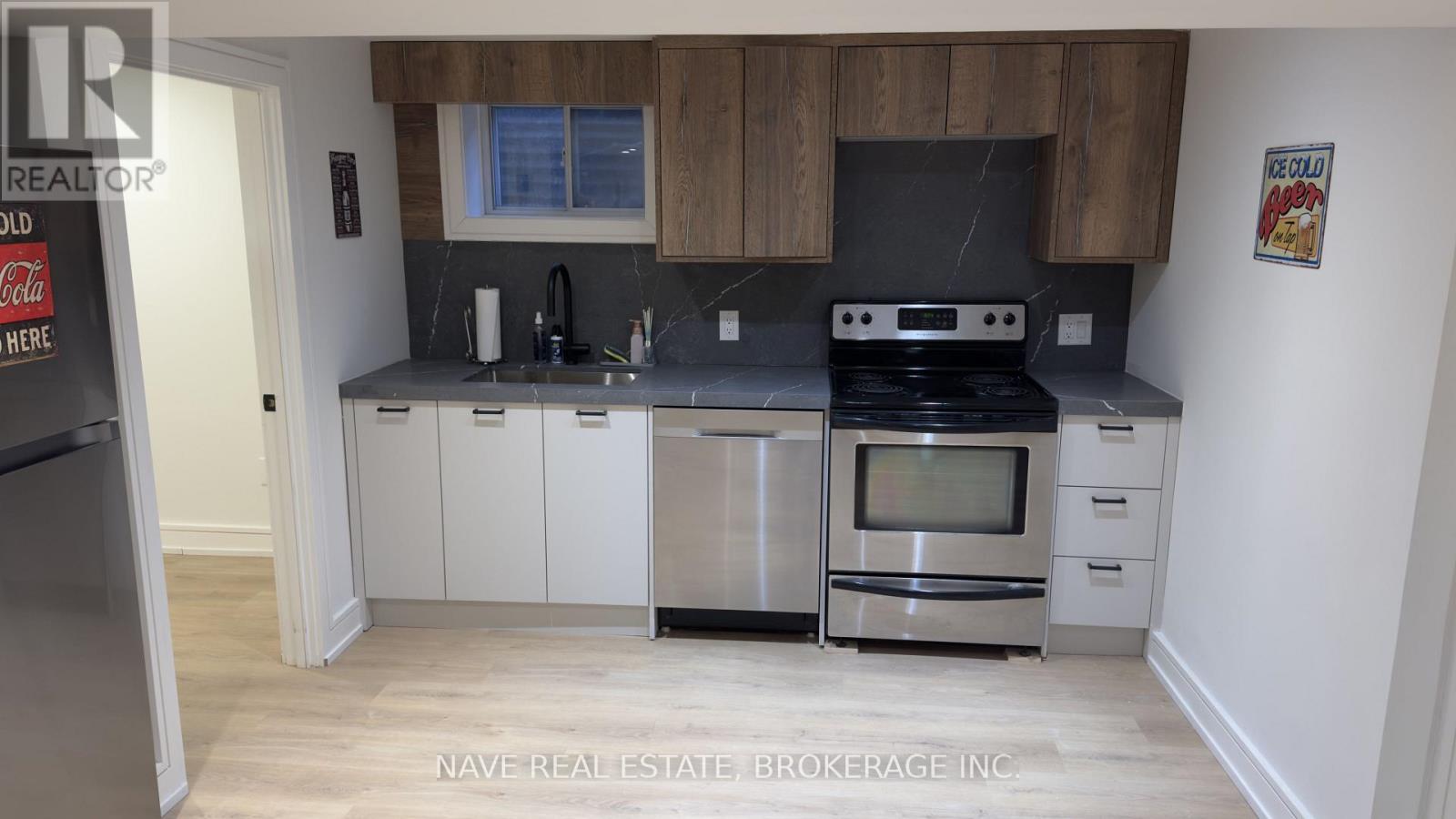 A kitchen with a Coca-Cola fridge and a stove top oven.