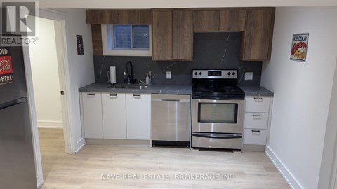 A kitchen with a Coca-Cola fridge and a stove top oven.