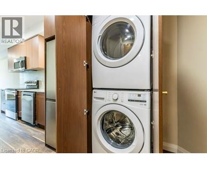 A washing machine is placed next to a dryer in a laundry room.