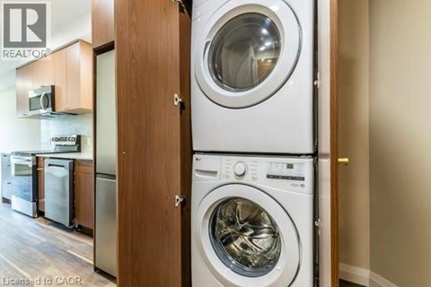 A washing machine is placed next to a dryer in a laundry room.