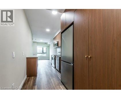 A kitchen with wooden cabinets and a refrigerator.