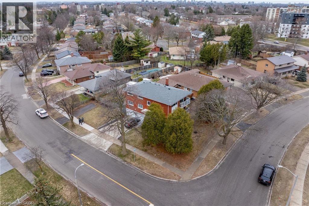A residential area with houses and cars.