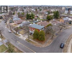 A residential area with houses and cars.