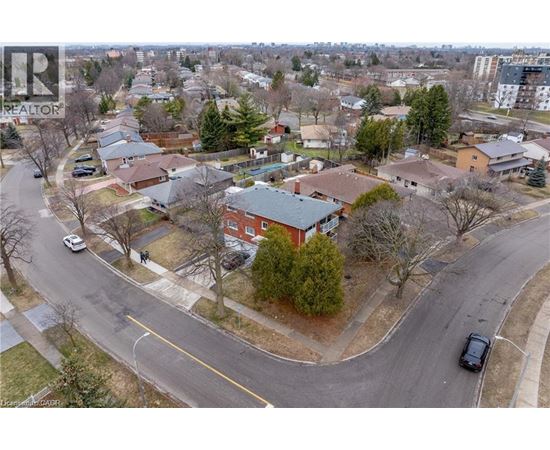 A residential area with houses and cars.