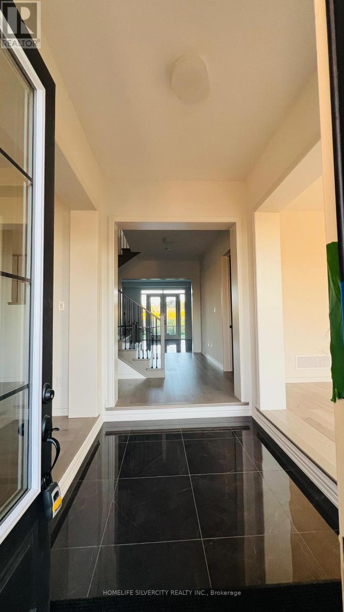 A hallway with a black floor and white walls.