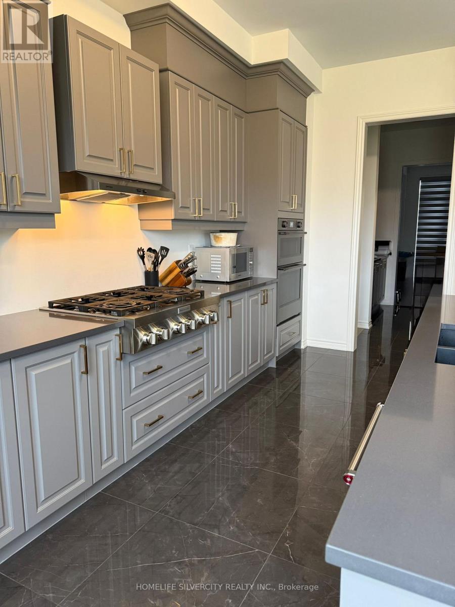 A kitchen with a stove top oven and cabinets.