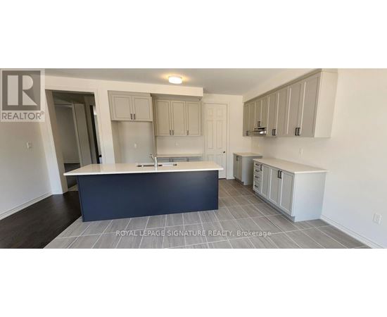 A kitchen with a large island and cabinets.
