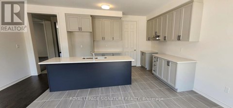 A kitchen with a large island and cabinets.
