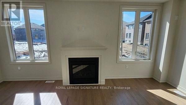 A room with a fireplace and two windows.