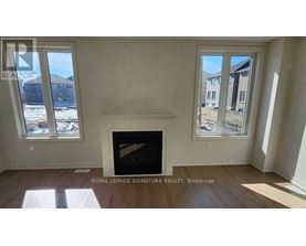 A room with a fireplace and two windows.