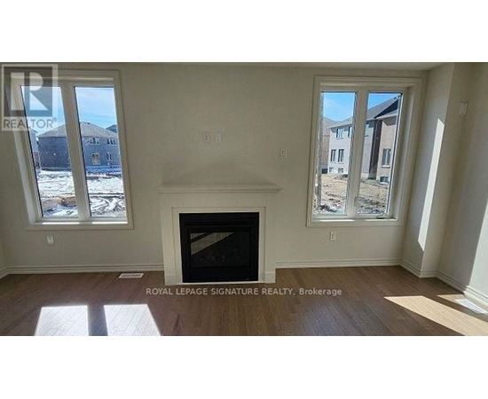 A room with a fireplace and two windows.