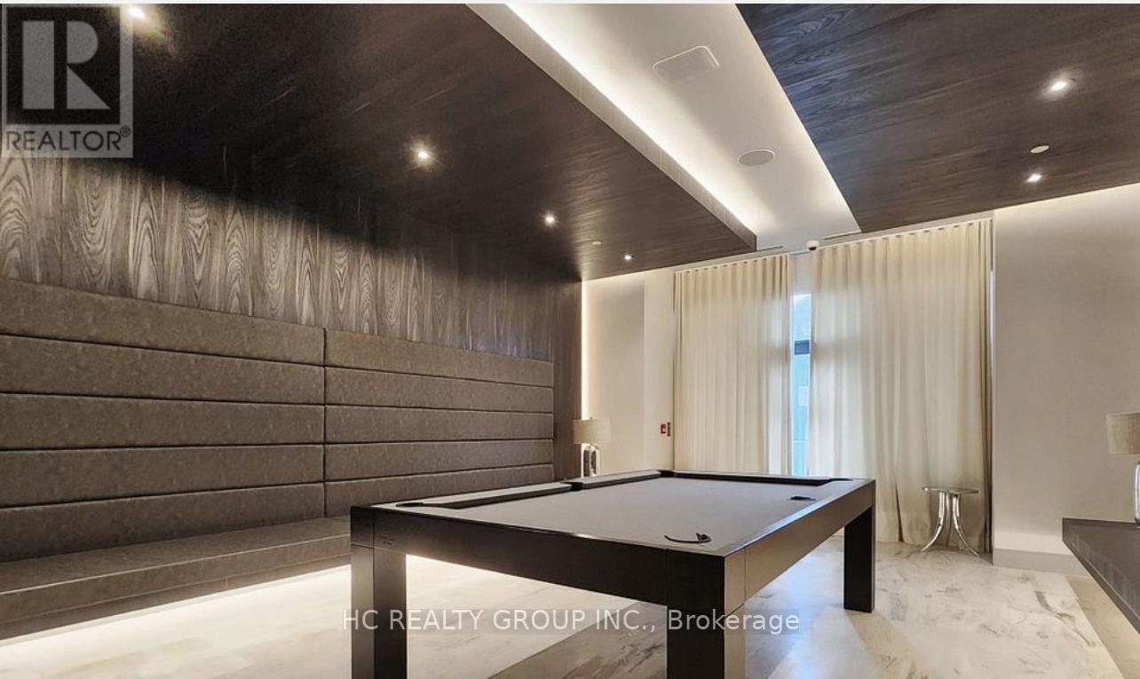 A pool table in a room with wooden walls and a carpeted floor.