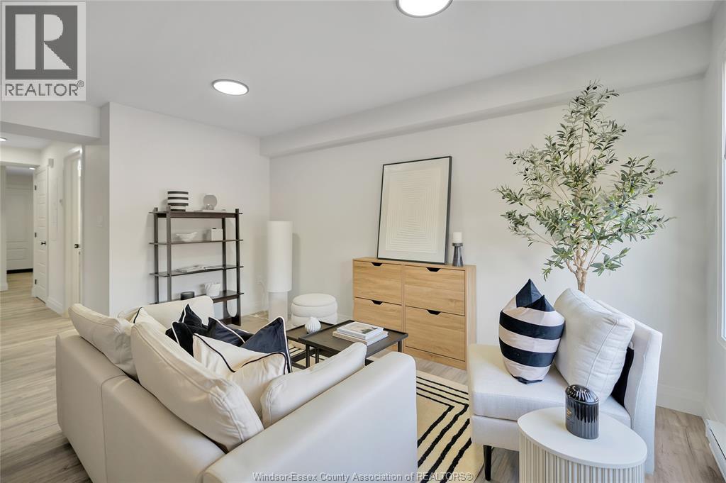 A living room with a white couch and a wooden side table.