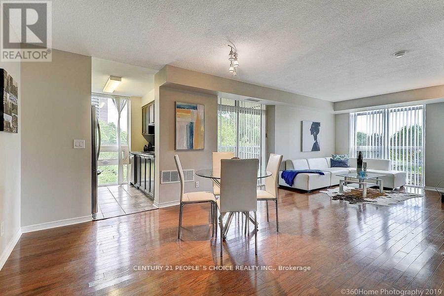 A living room with a white couch and a wooden floor.