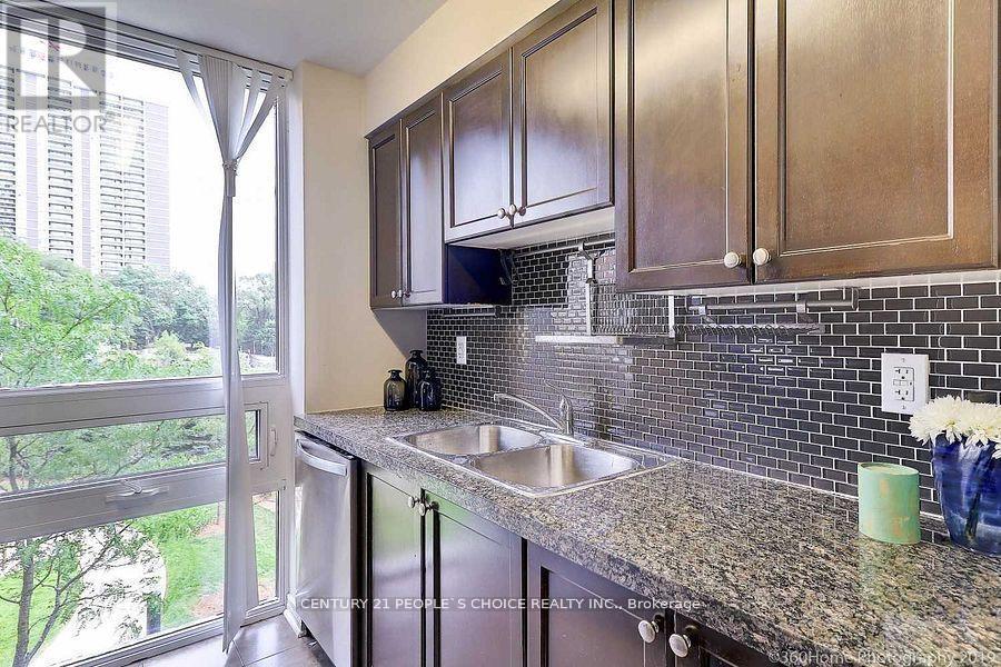 A kitchen with granite countertops and stainless steel appliances.