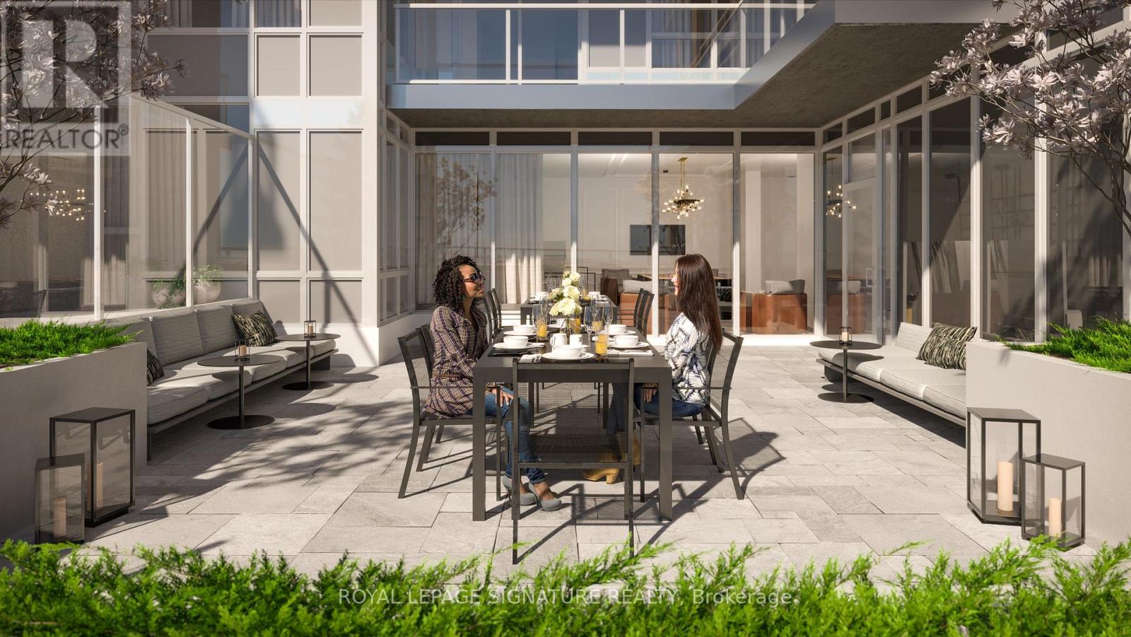 A modern outdoor dining area with a table set for two.