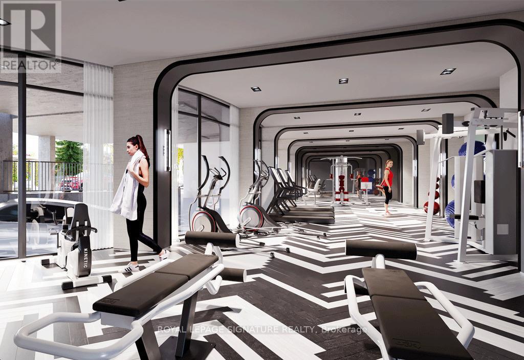 A woman is standing in a modern gym with a variety of exercise equipment.