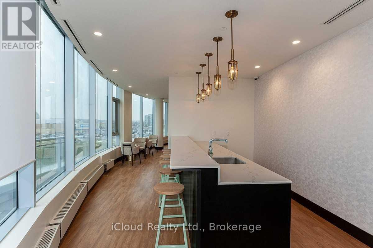 A modern kitchen with a long counter and bar stools.