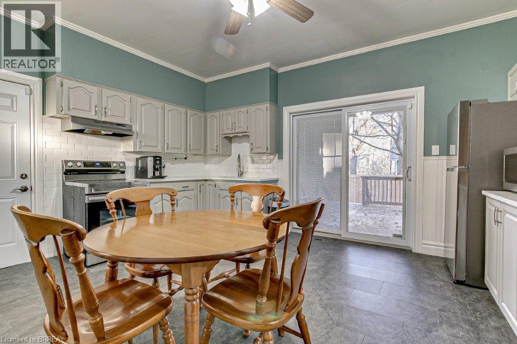 A kitchen with a table and chairs.