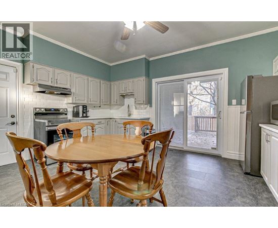 A kitchen with a table and chairs.
