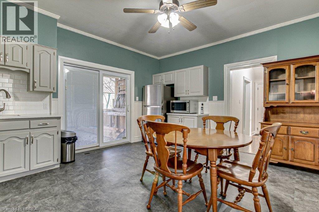 A dining room with a table and chairs.