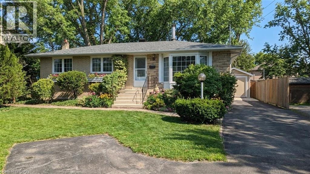 A house with a lawn and a driveway in front.