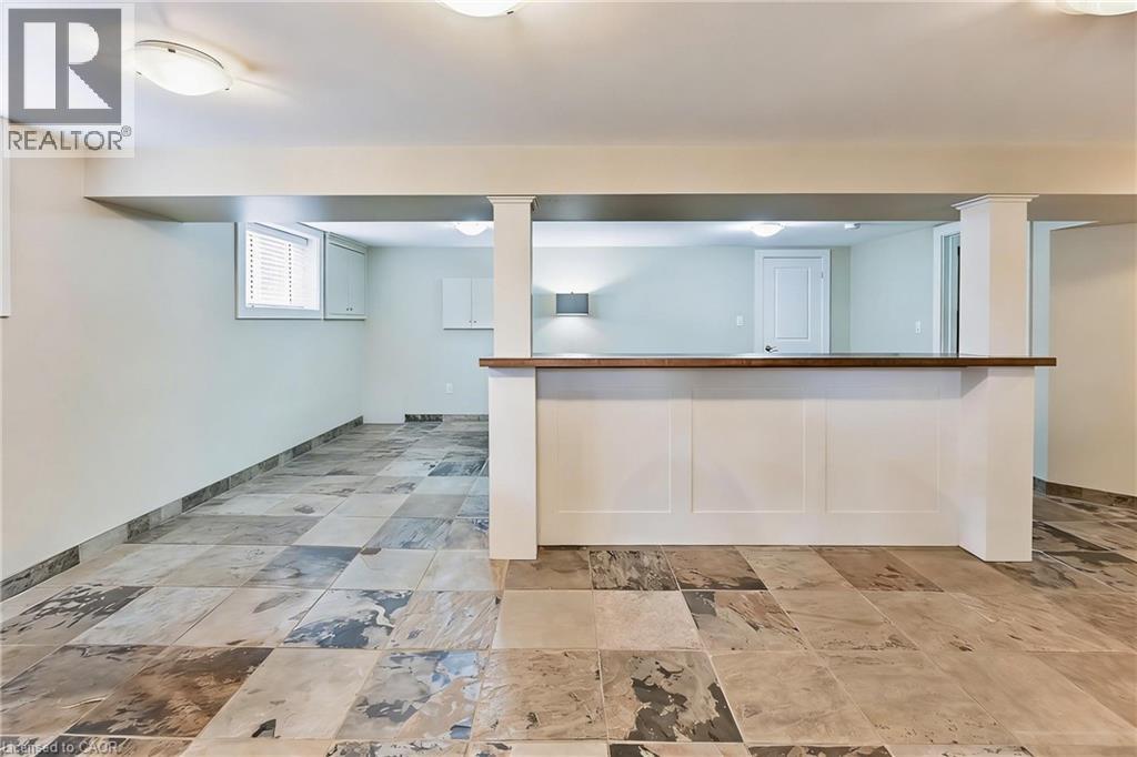 A spacious room with a marble floor and a white wall.