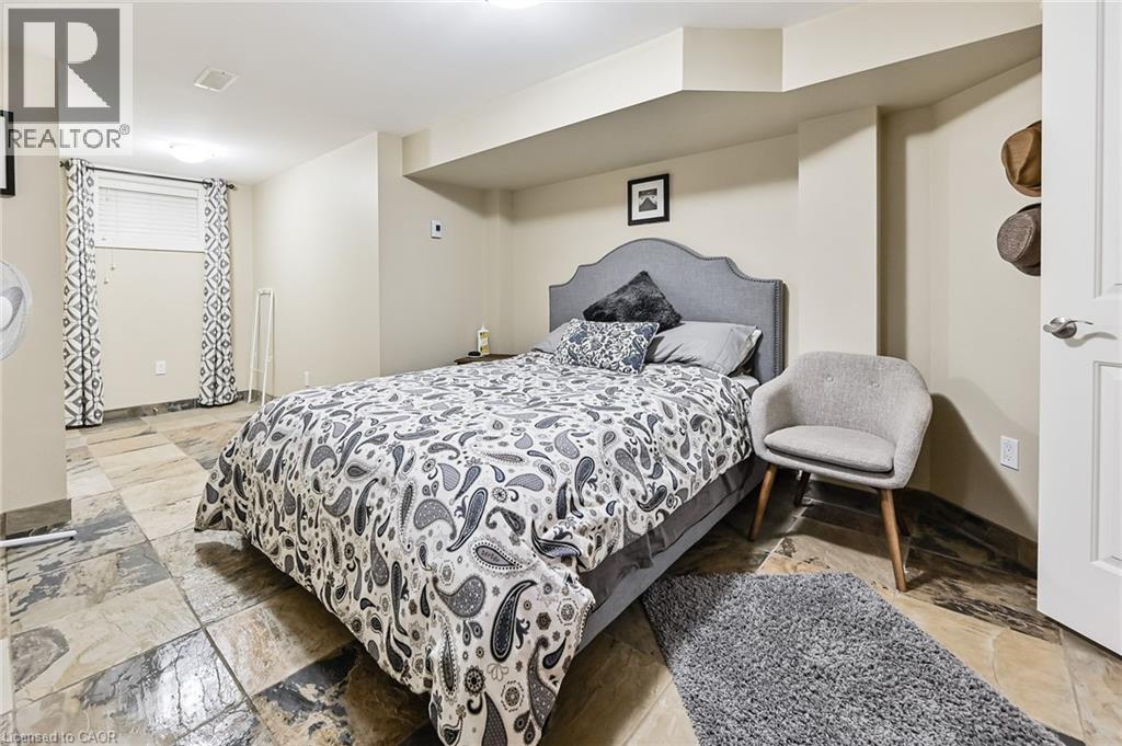 A bedroom with a large bed and a chair.