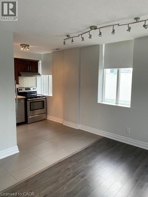 A well-lit kitchen with a stove top oven and a microwave.