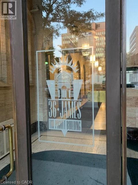 A window with a sign that says "36 JAMES" on it.