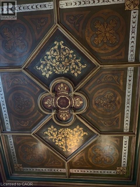 A ceiling with a decorative design and a cross in the middle.