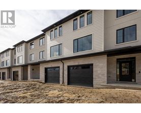 A row of new houses with garages are for sale.