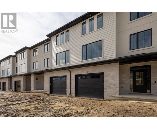 A row of new houses with garages are for sale.
