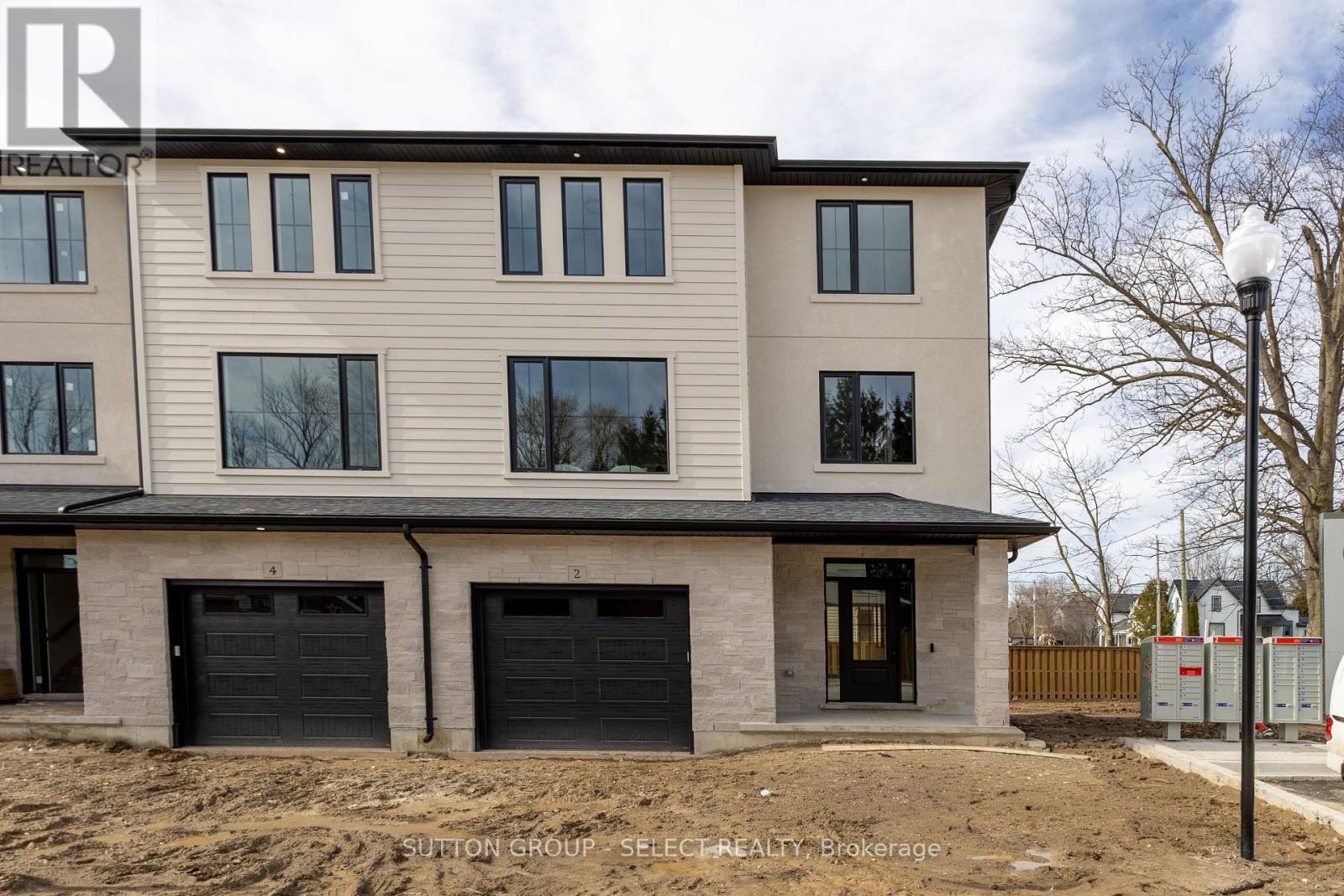 A modern two-story house with a garage is under construction.