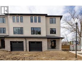 A modern two-story house with a garage is under construction.