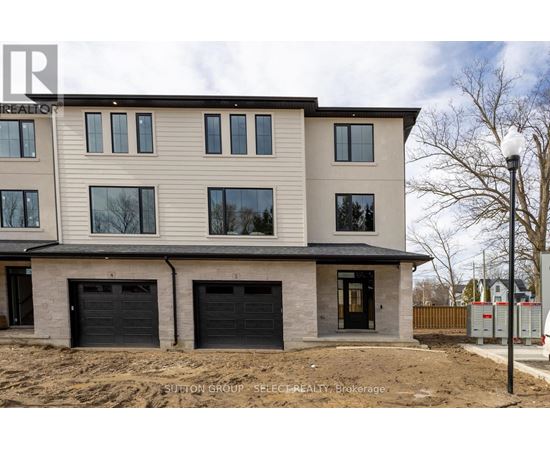 A modern two-story house with a garage is under construction.