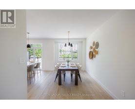 A dining room with a table set for four.