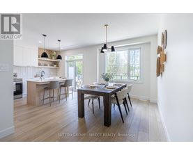 A modern kitchen with a dining table set for four.