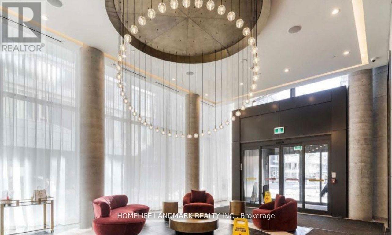 A reception area with a chandelier, red chairs, and a sign that says "HOMELESS LANDMARK REALTY INC Brokerage".