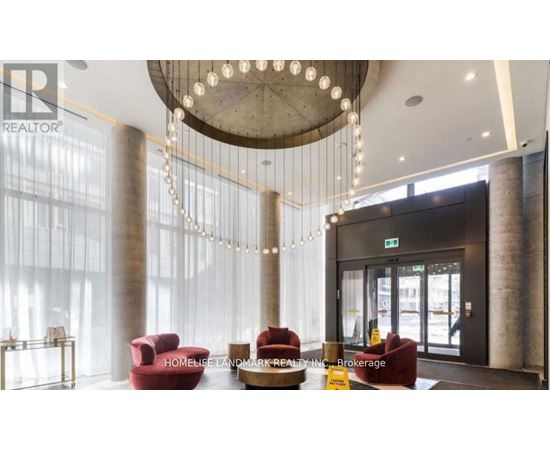 A reception area with a chandelier, red chairs, and a sign that says "HOMELESS LANDMARK REALTY INC Brokerage".
