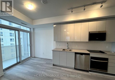 A kitchen with white cabinets and stainless steel appliances.