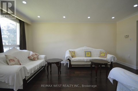 A living room with white couches and a black coffee table.