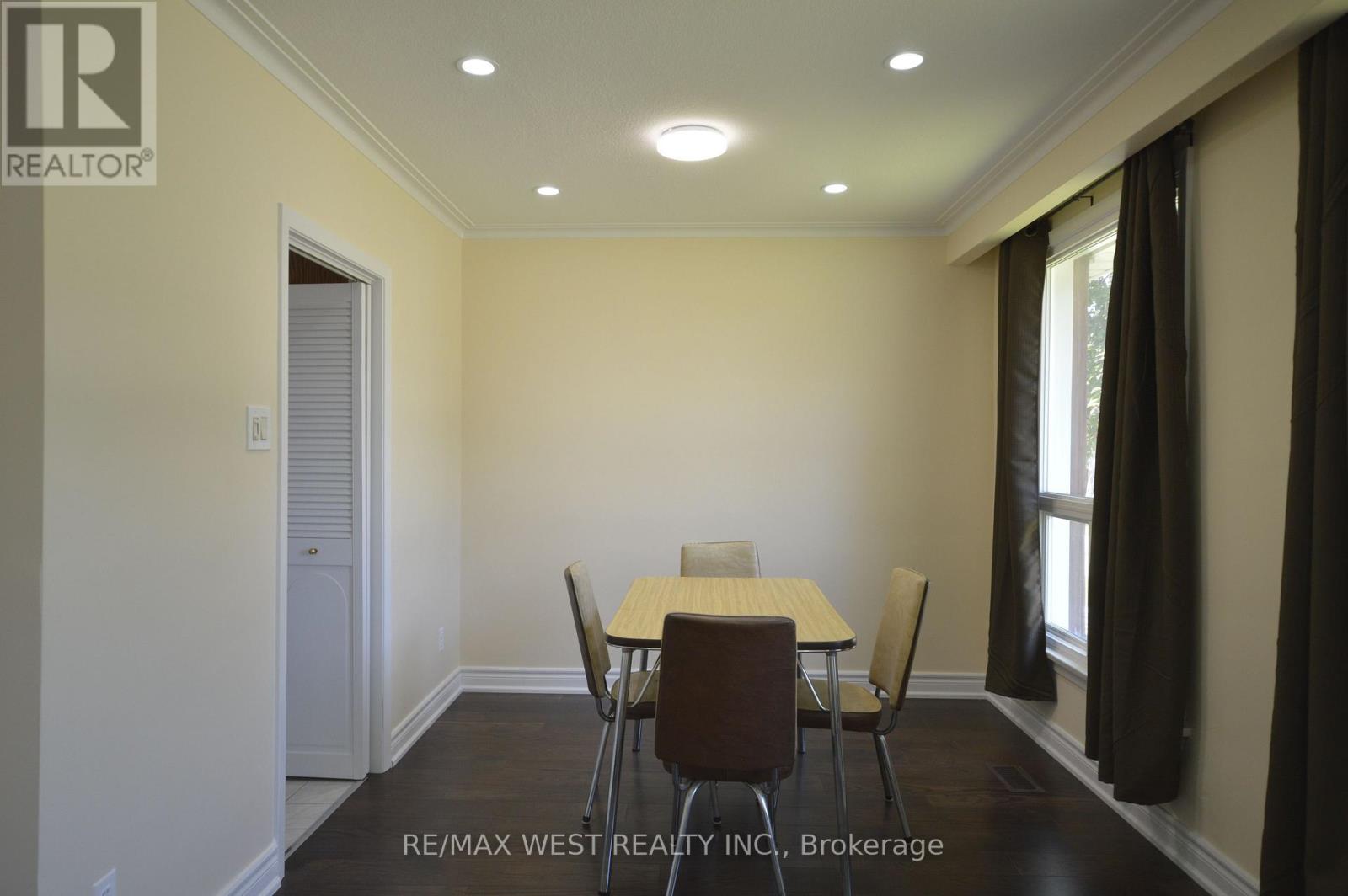 A dining room with a table and chairs.