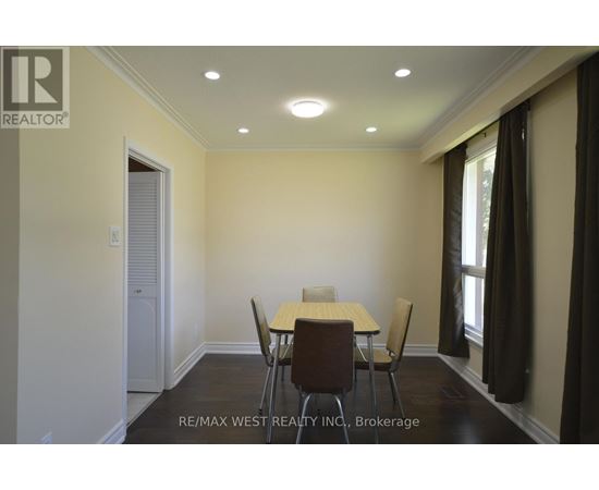 A dining room with a table and chairs.